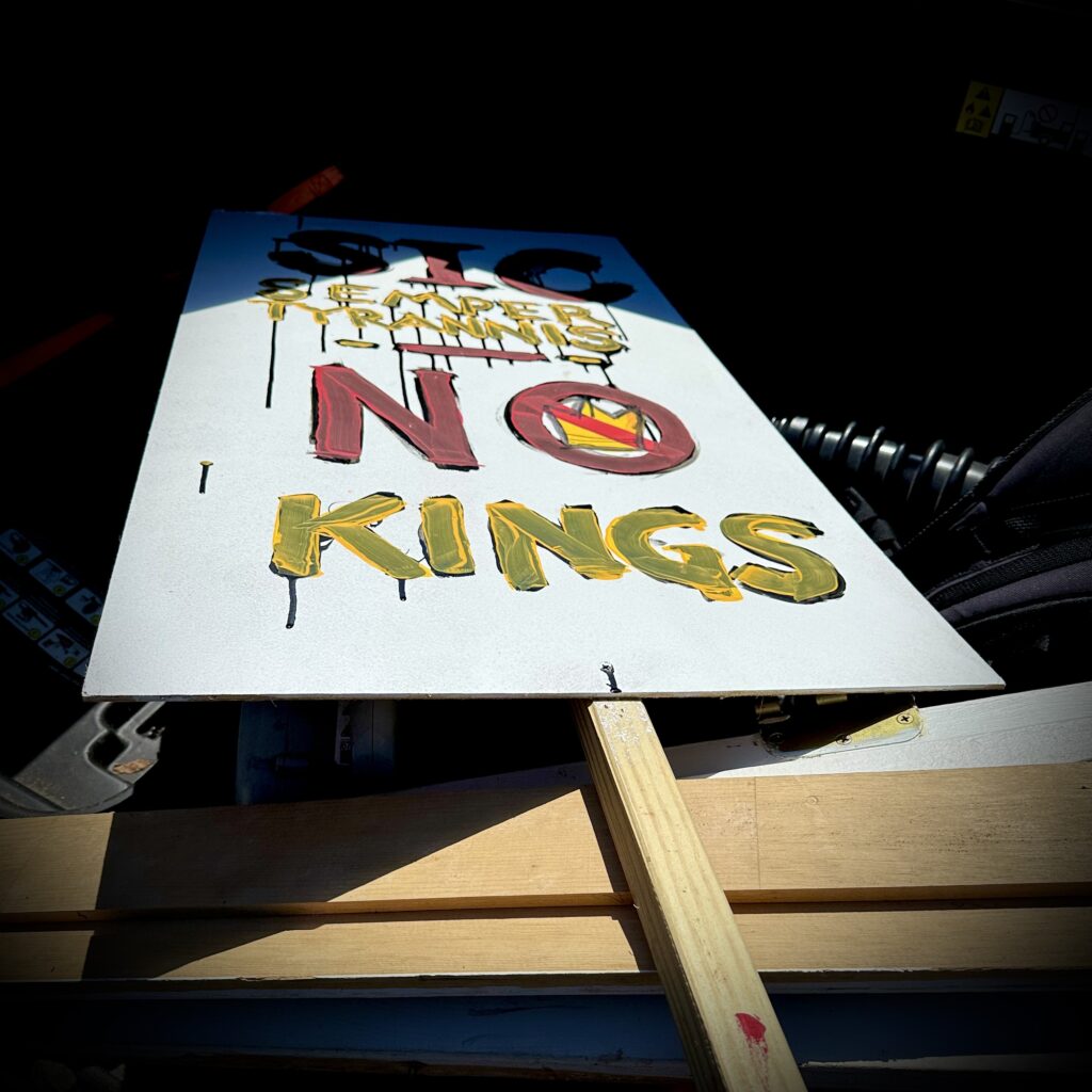 A homemade protest sign rests in the back of the author's truck.