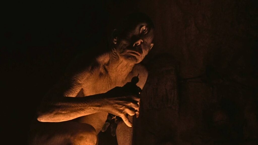 The Cyclops prepares to munch on a Greek soldier.